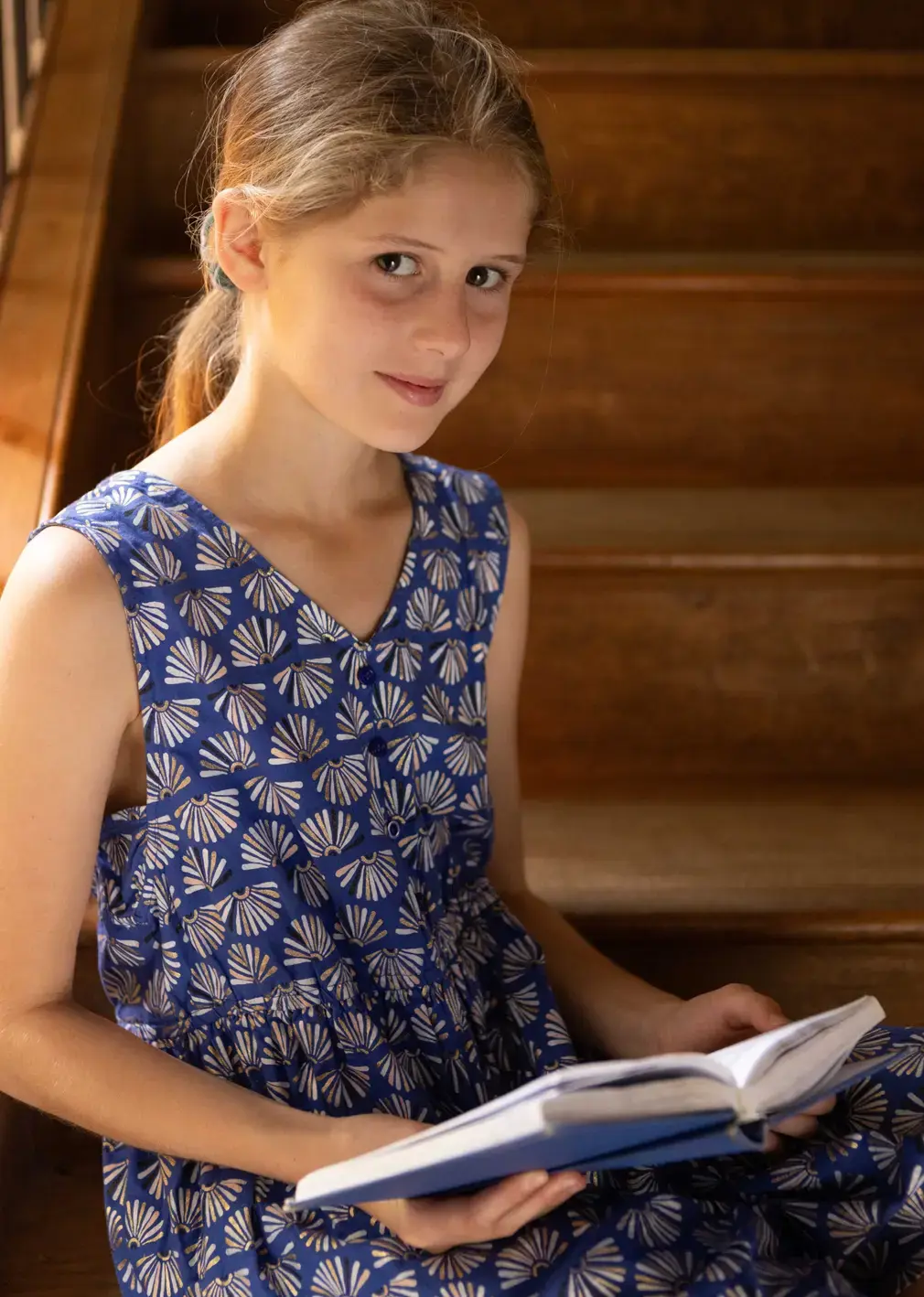 Student Reading Book on Steps