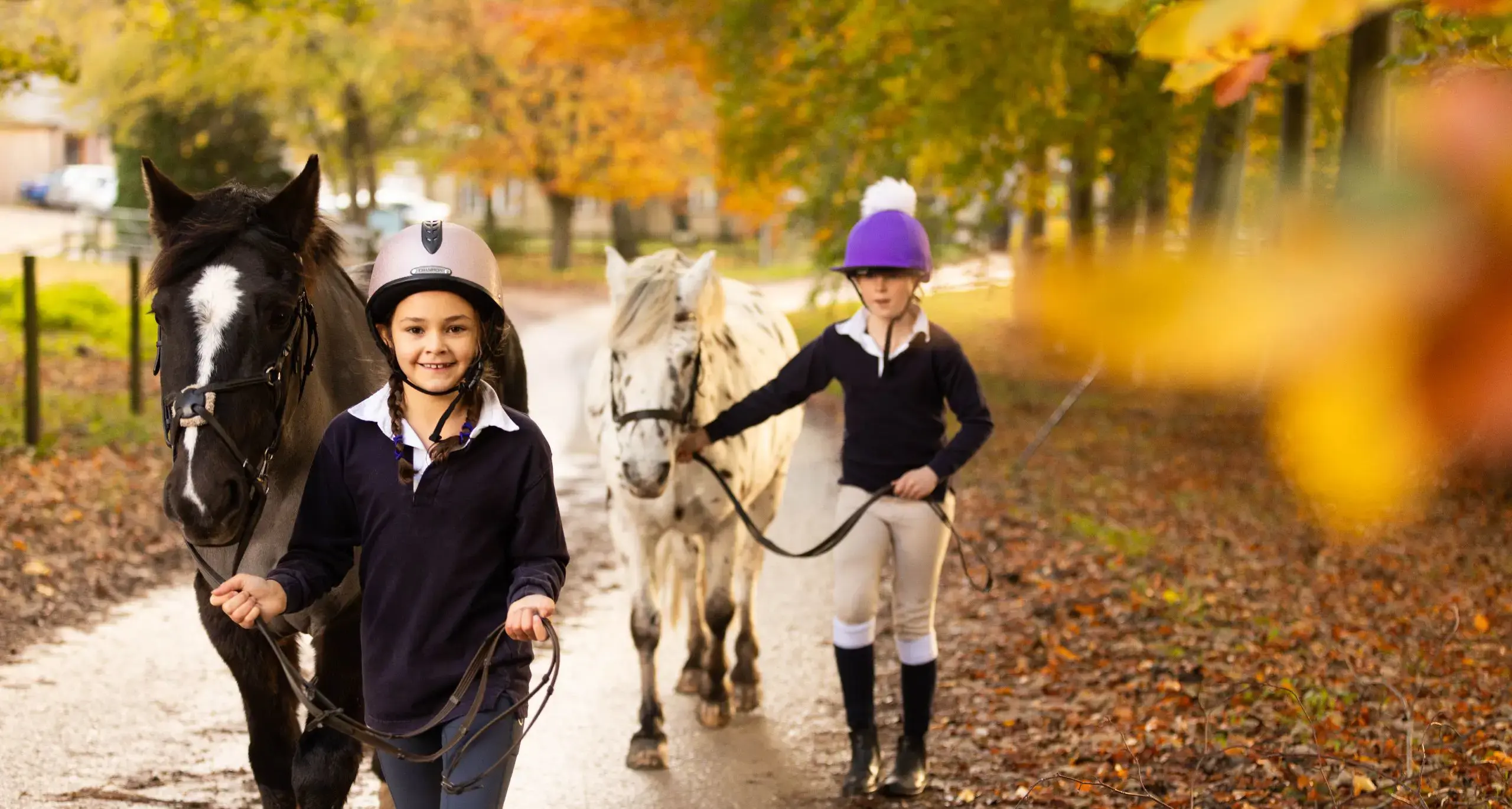 Students Leading Horses and Smiling