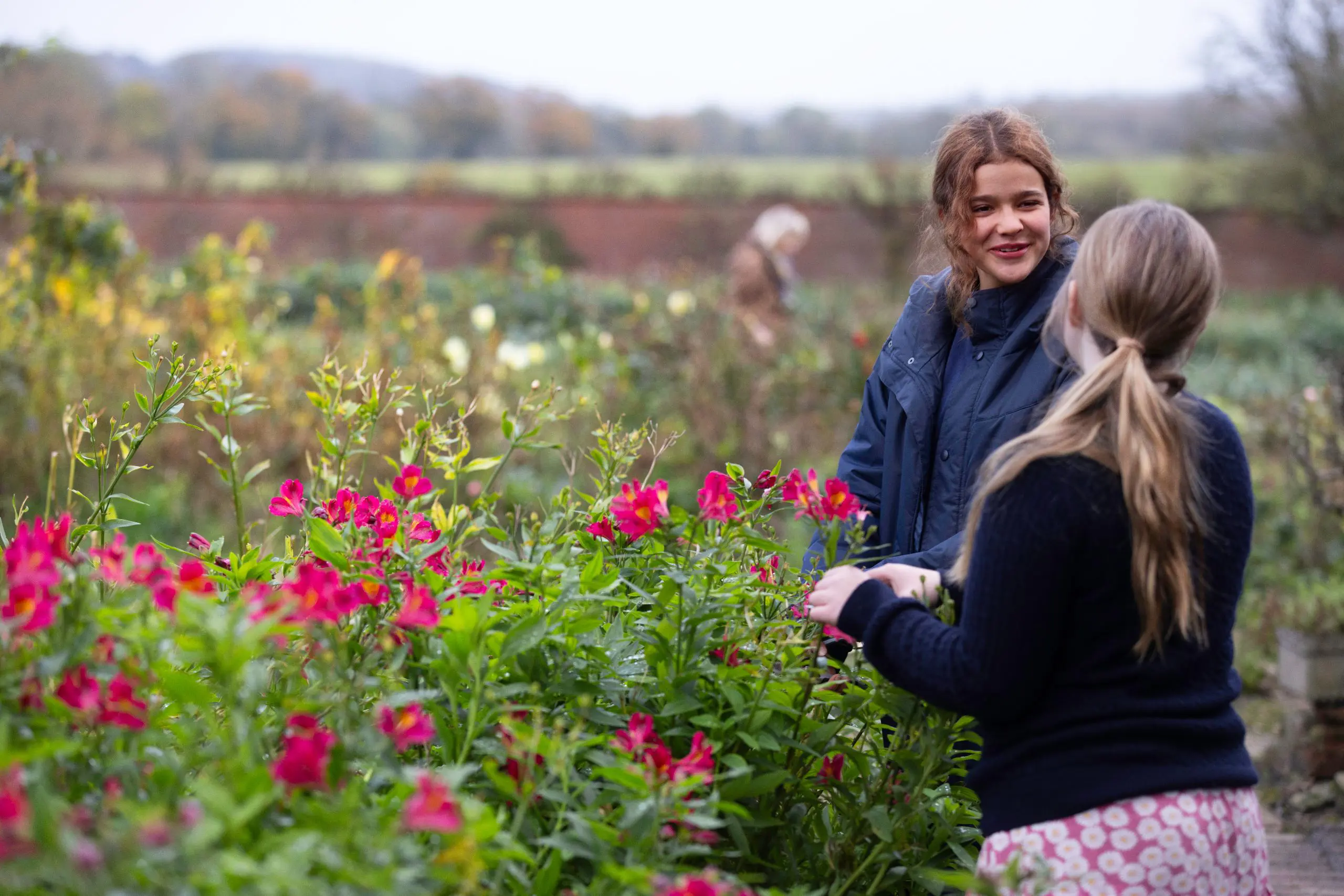Students Chatting While Gardening Flowers