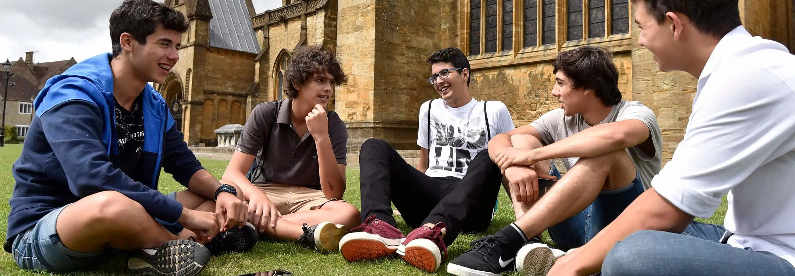 International Students Sitting on Campus Grounds
