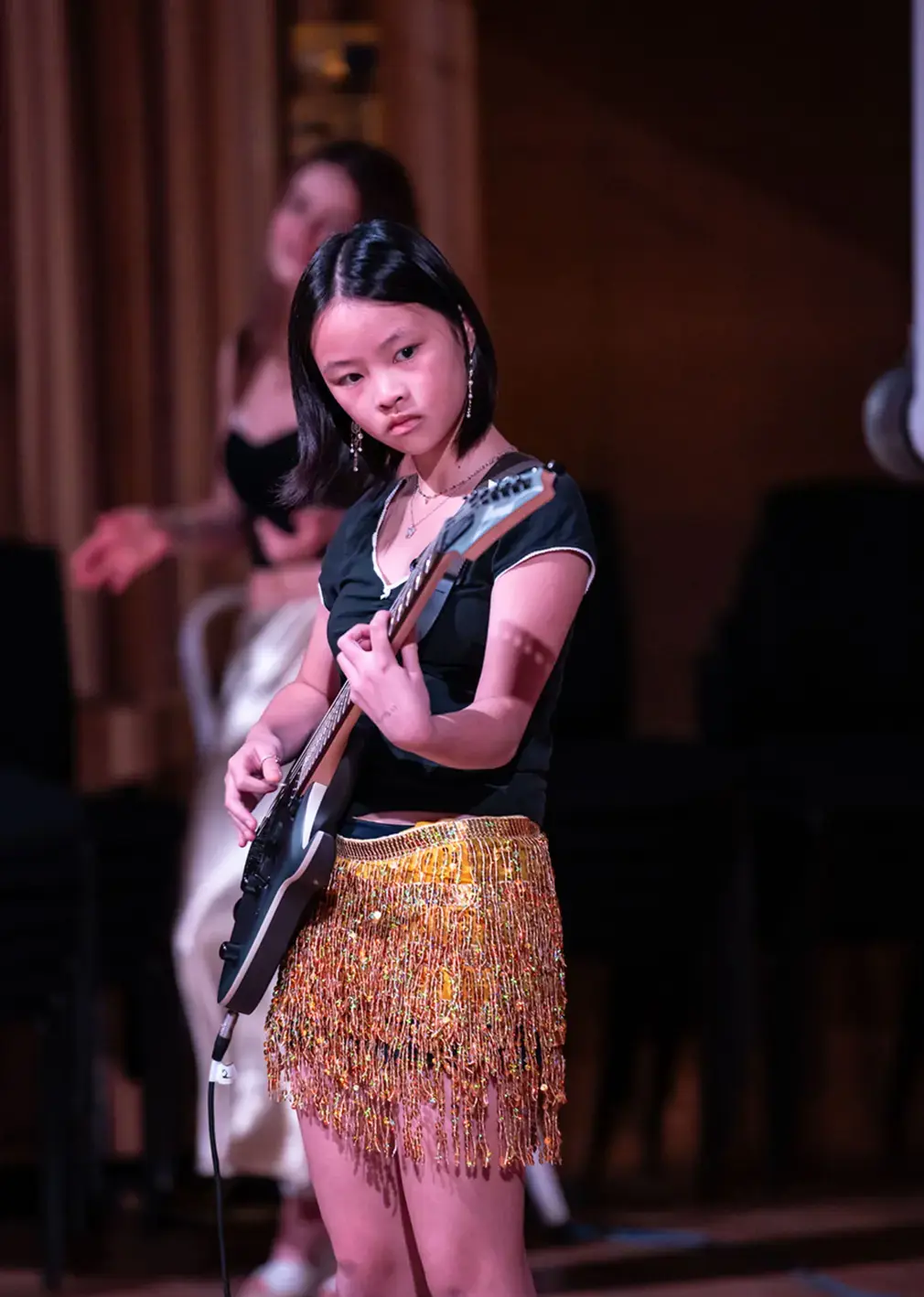 International Student Playing Guitar in Stage