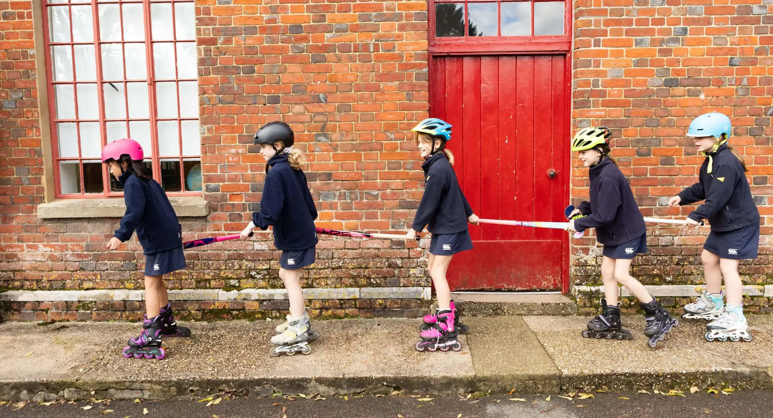 Hanford Prep pupils Rollerblading together.