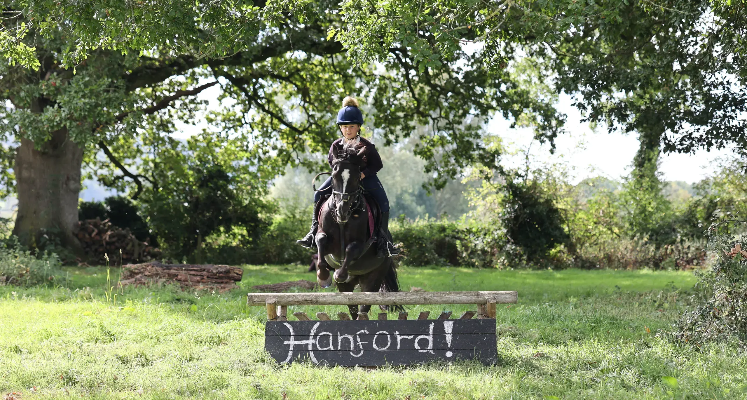 Student Jumping Over Obstacle While Riding Horse
