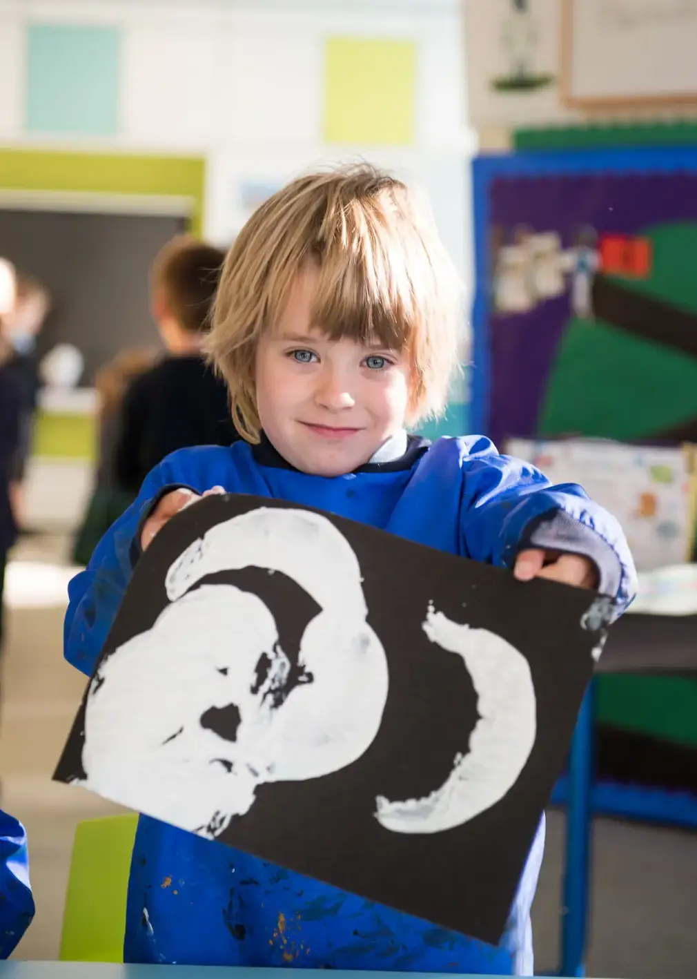 Student Showing off His Hand Made Art