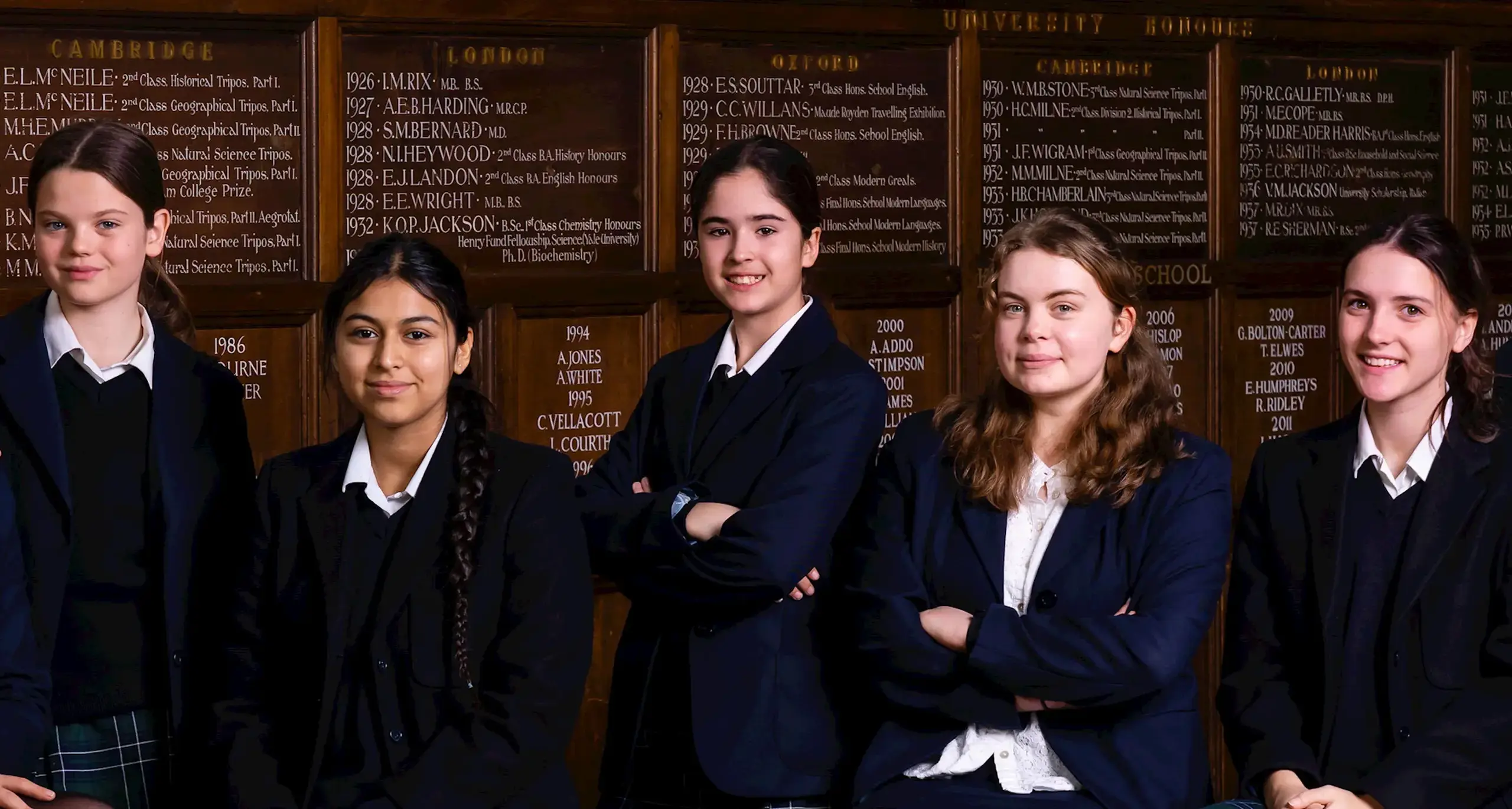 Students in Front of Donation Plaques