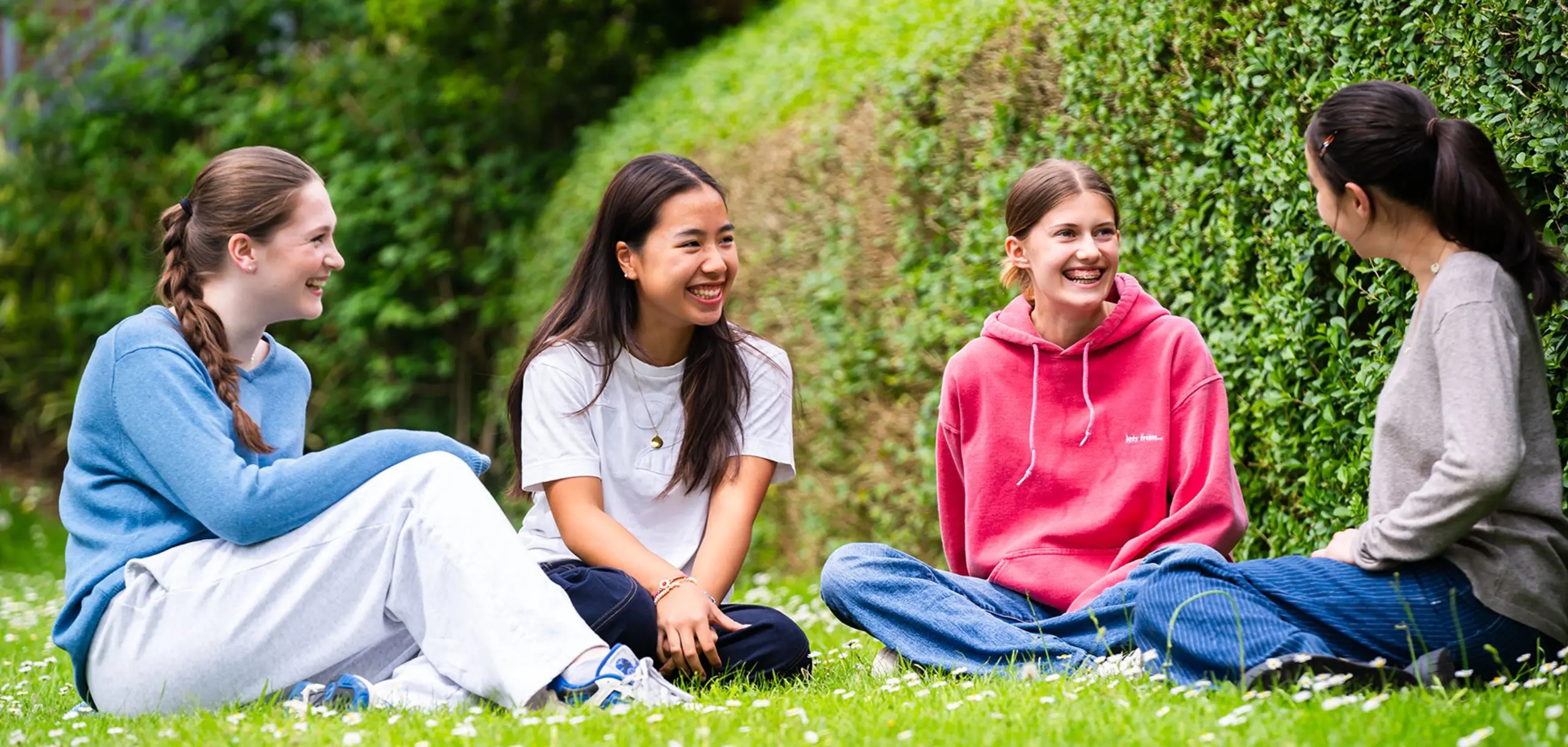 Students Relaxing in Garden Together