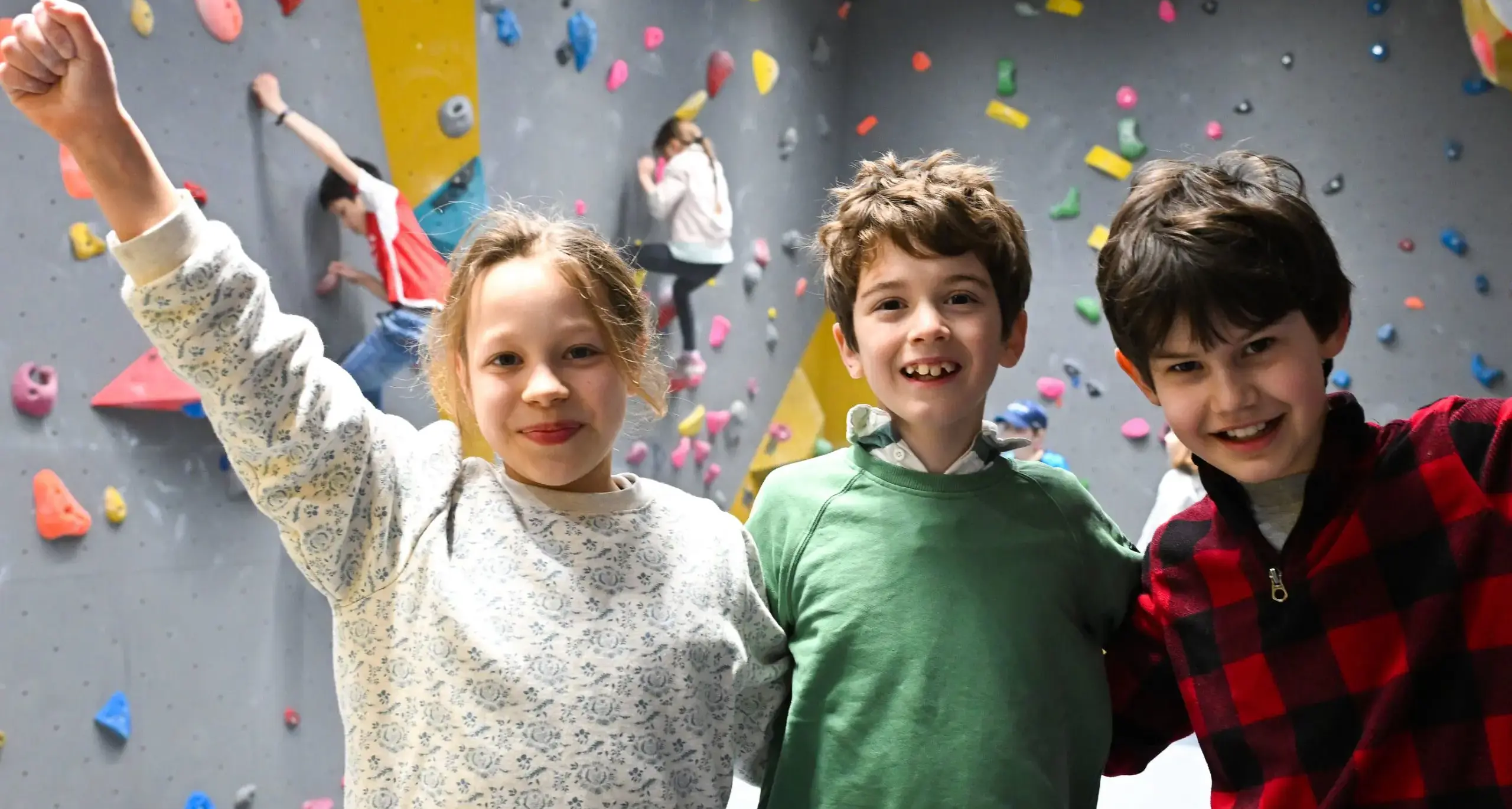Student Smiling and Doing Rock Climbing