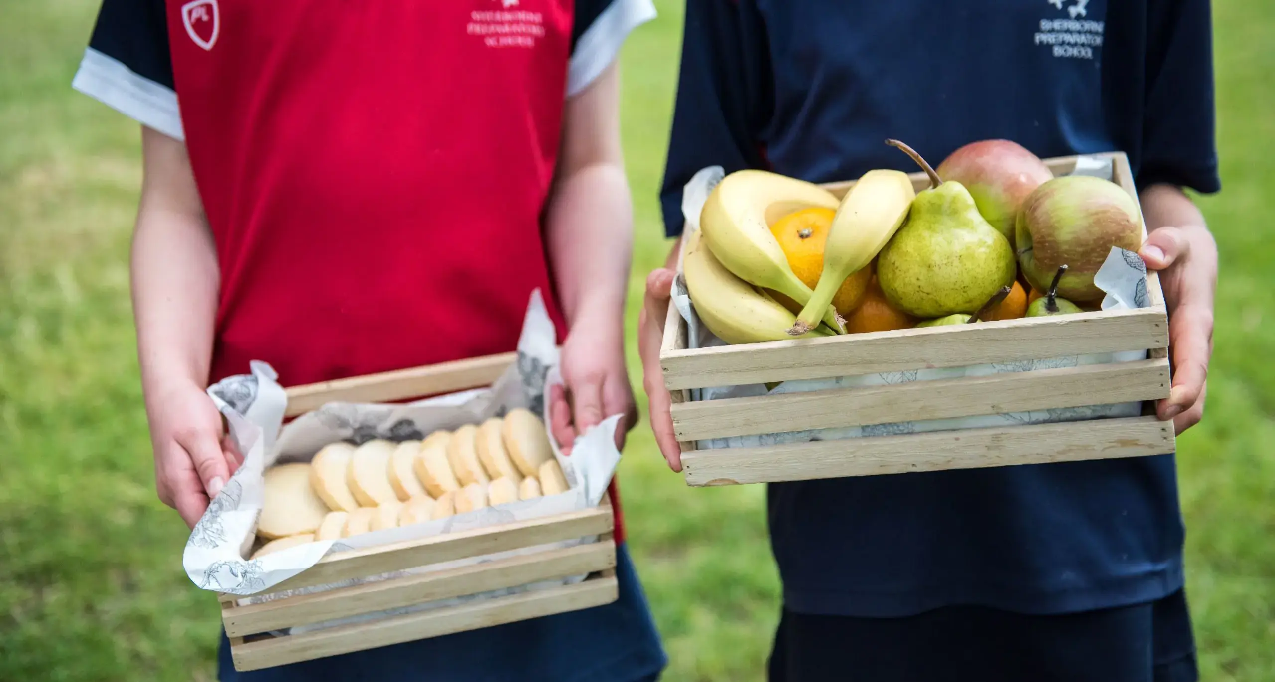 Students Holding Fruit Boxes