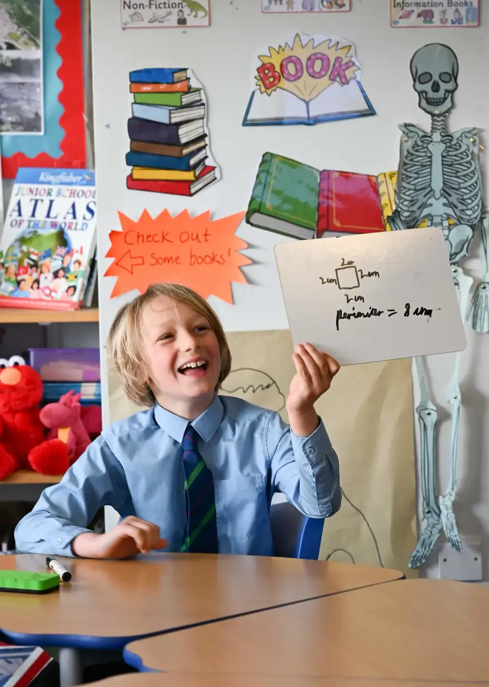 Student in Class Holding Drawing