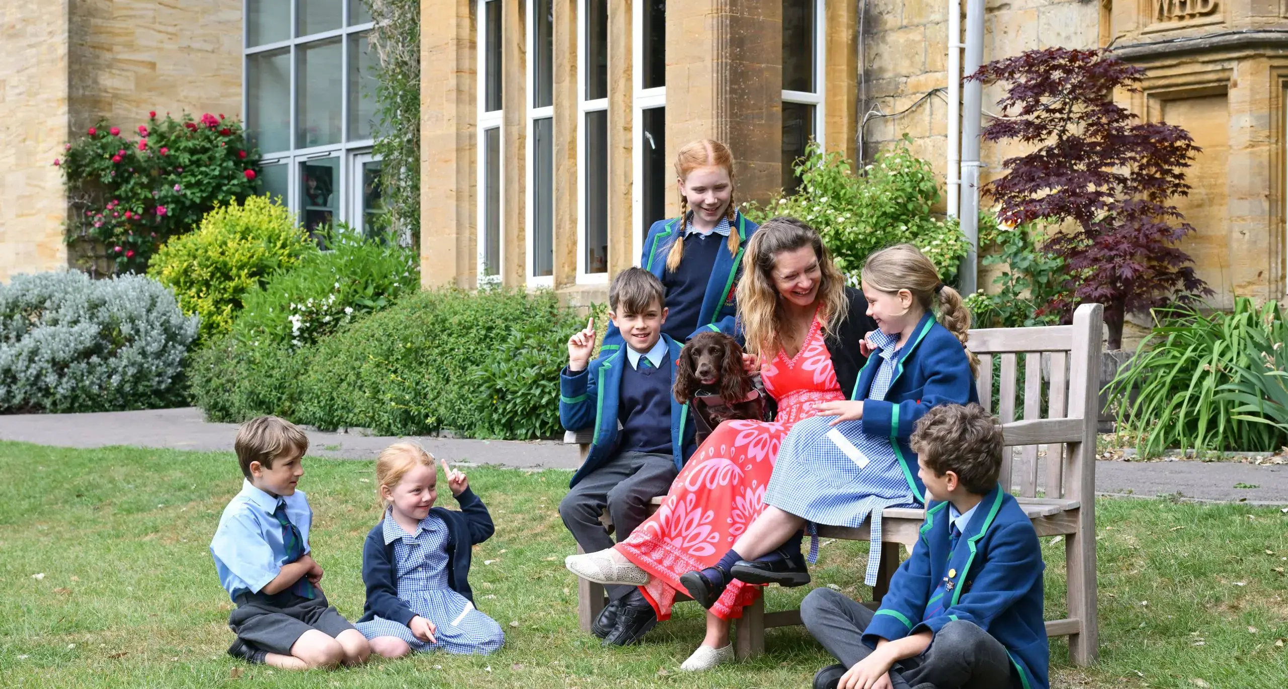 Staff with Students in Campus Garden