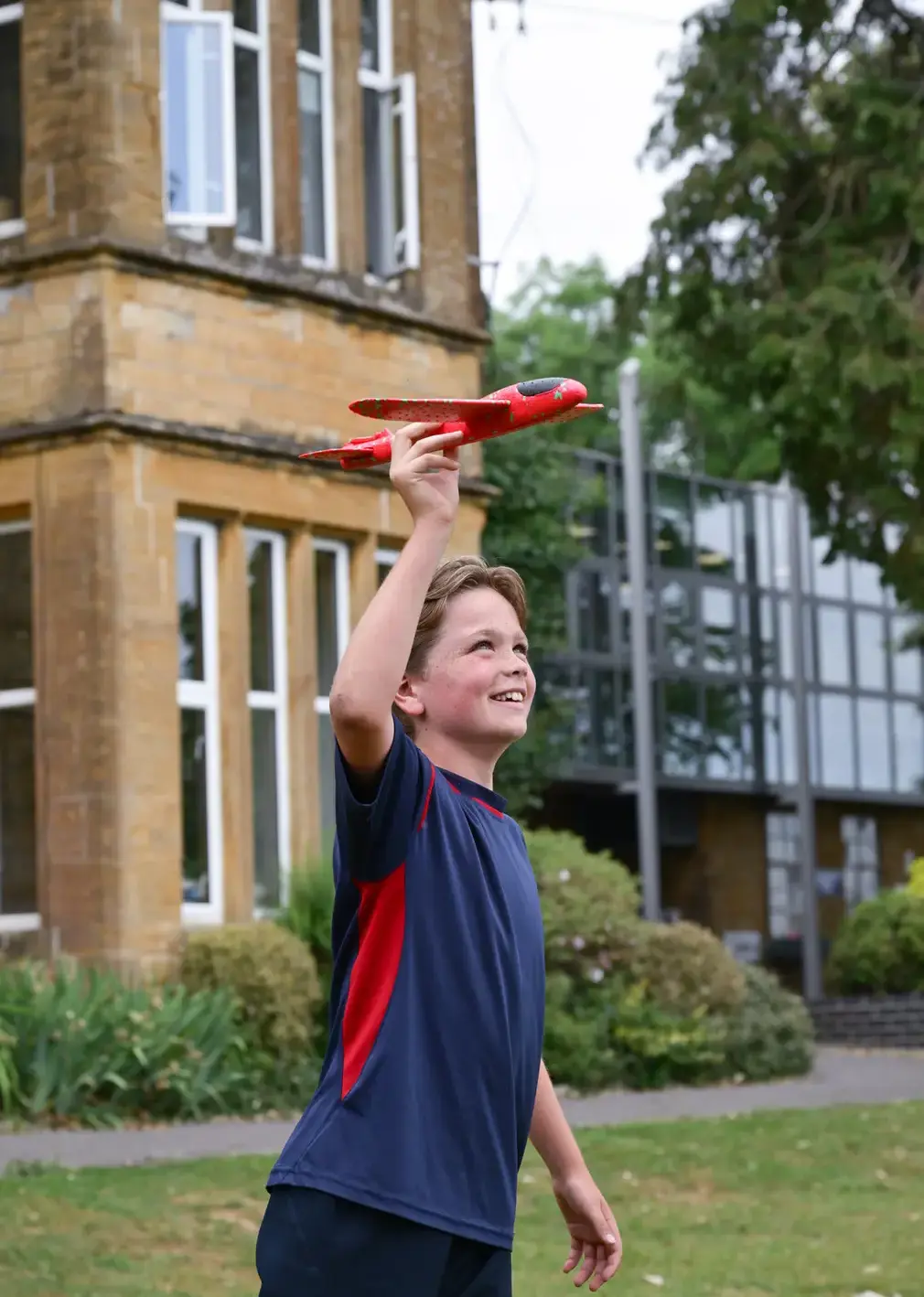 Student flying toy aeroplane