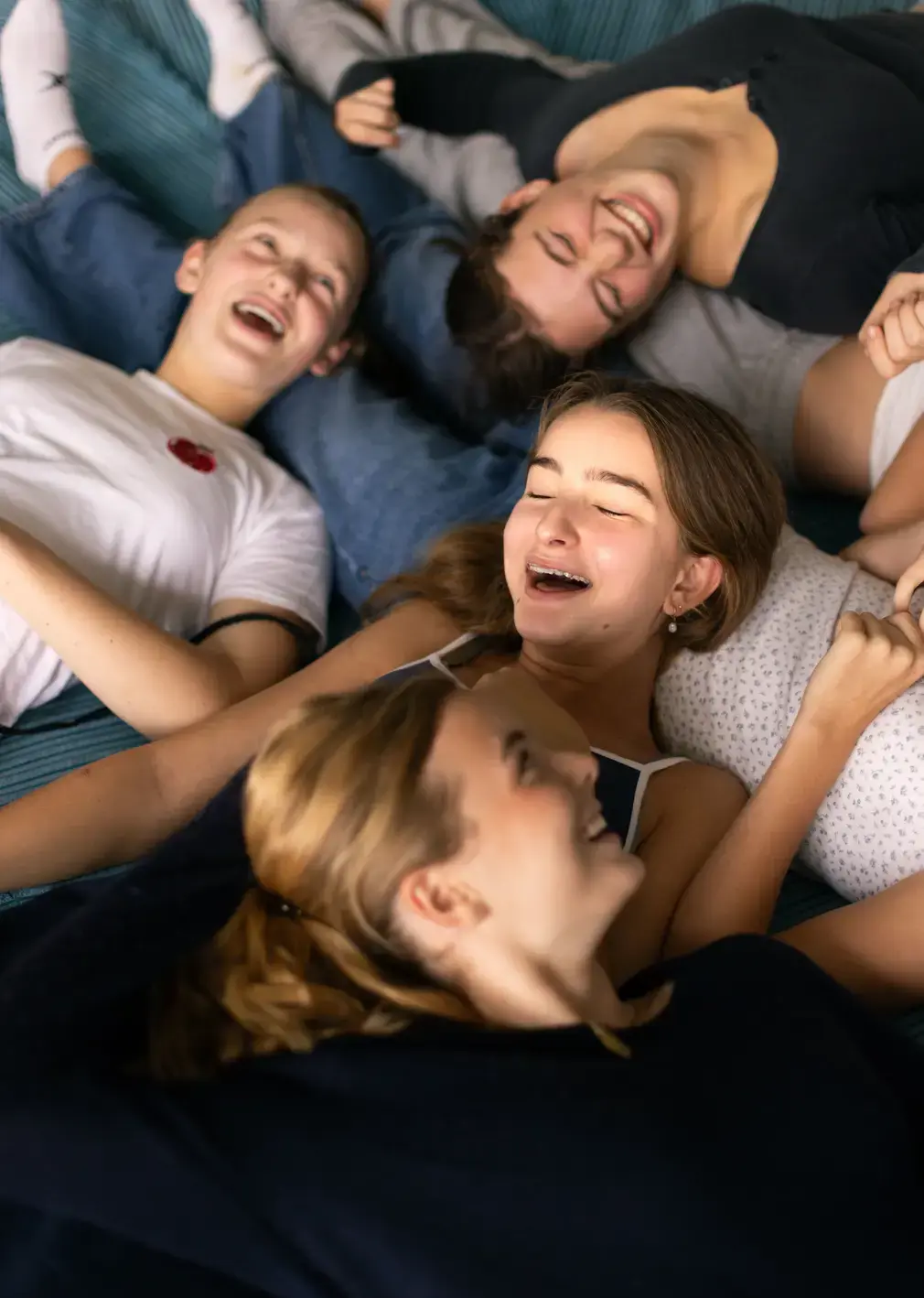 Girls laughing on bed