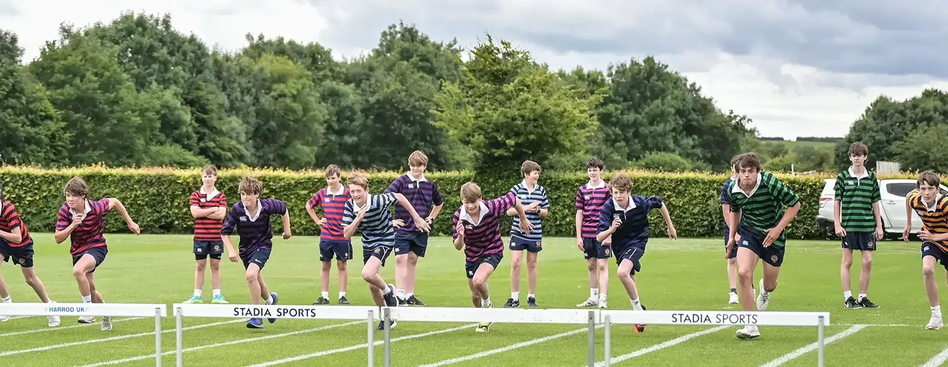 Boys Running Track in Athletics Class