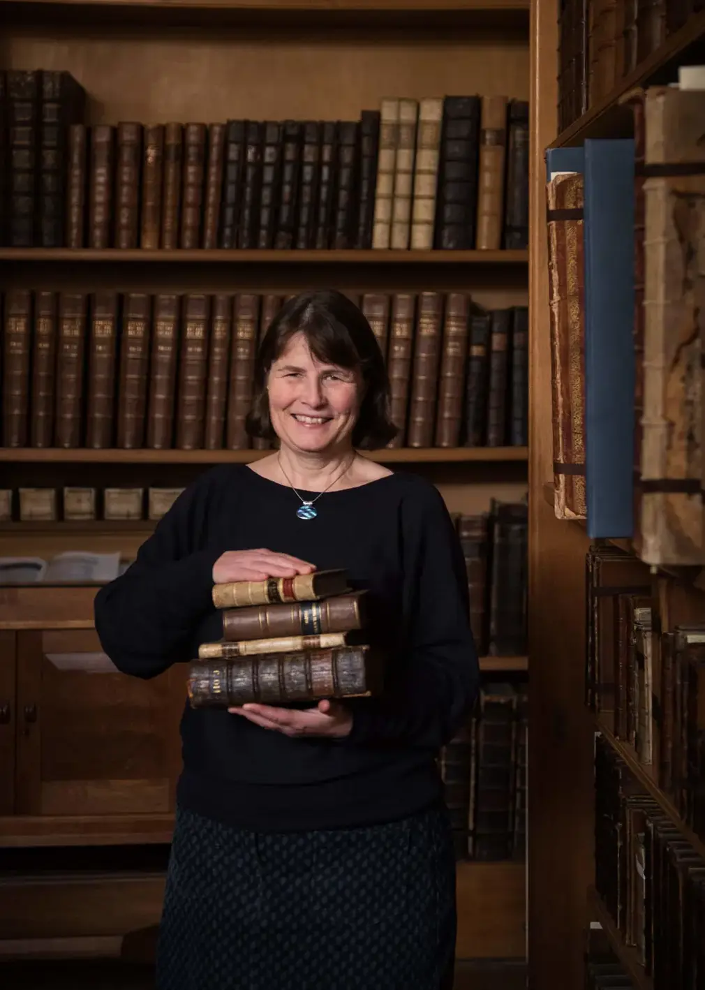 Librarian in Archives Smiling at Camera