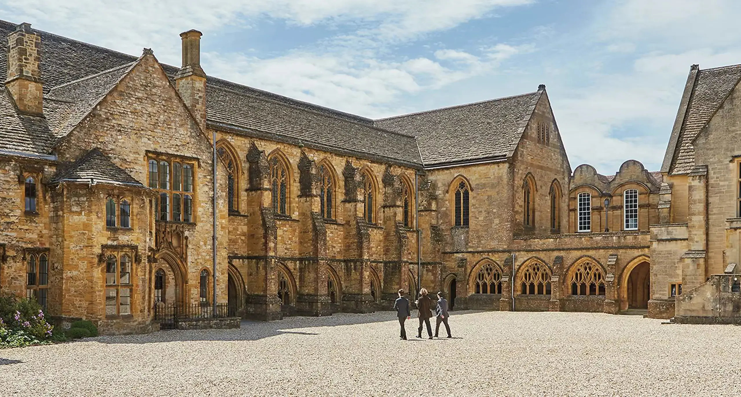 Staff Walking through Campus Courtyard